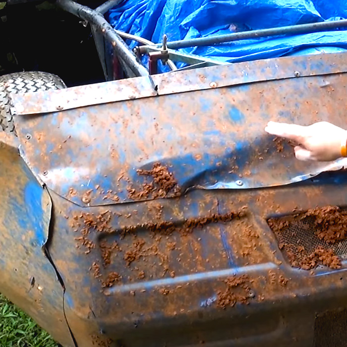 A race car covered in mud is about to get washed with ProGlow powersports wash.